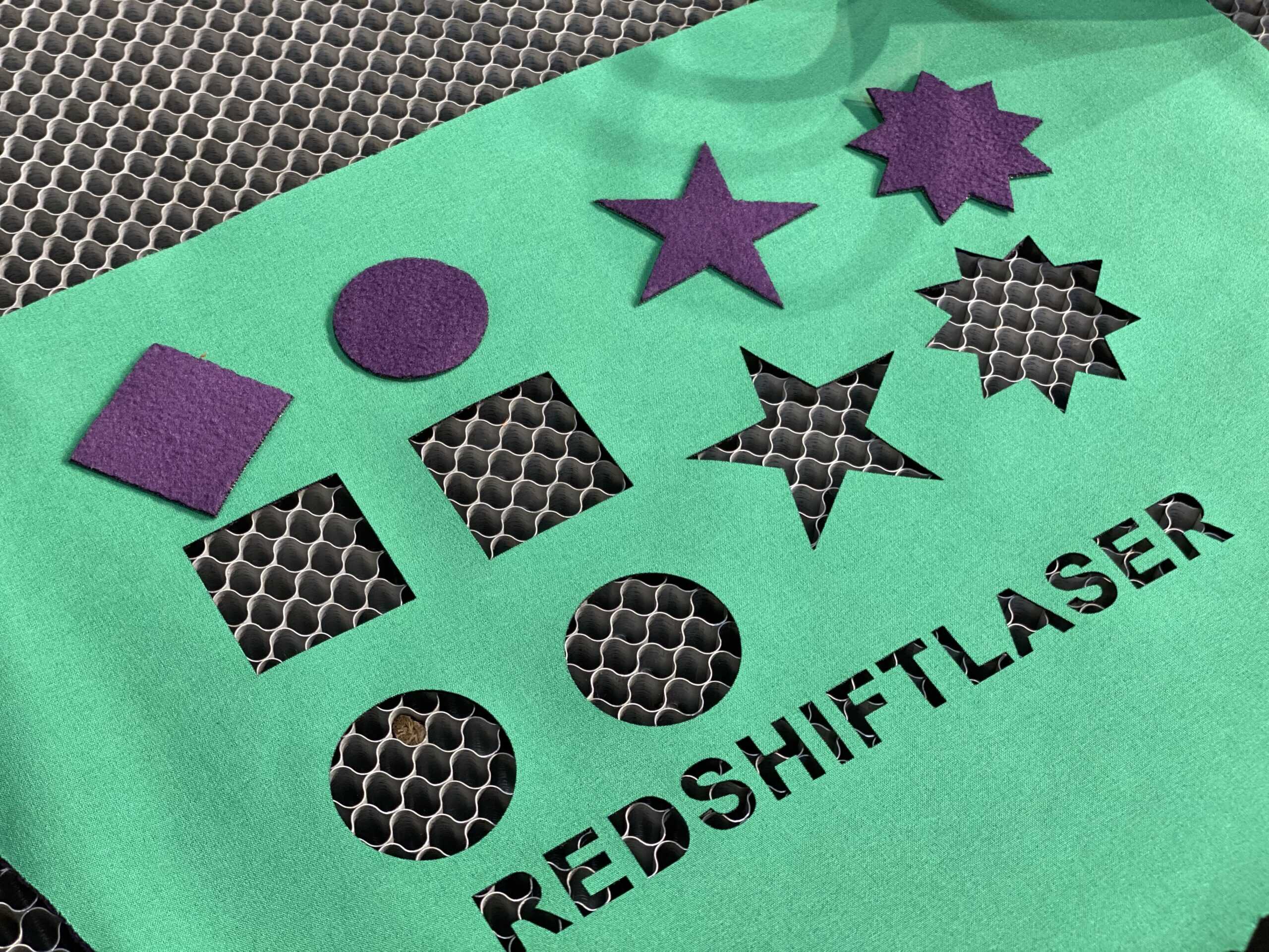 laser cutting an intricate pattern on fabric