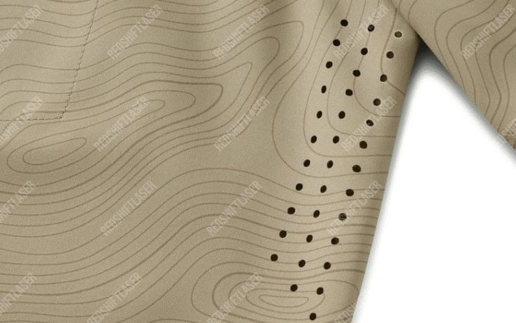 A CO2 laser precisely perforating a pattern onto high-tech sportswear fabric