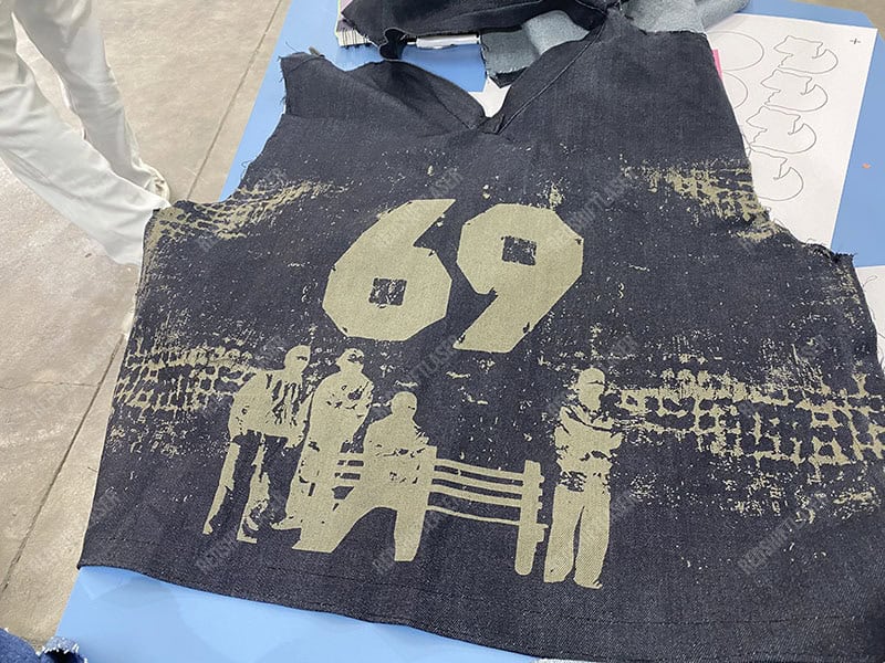 Laser effect on denim fabric A close-up macro shot showing laser-faded denim next to untouched denim