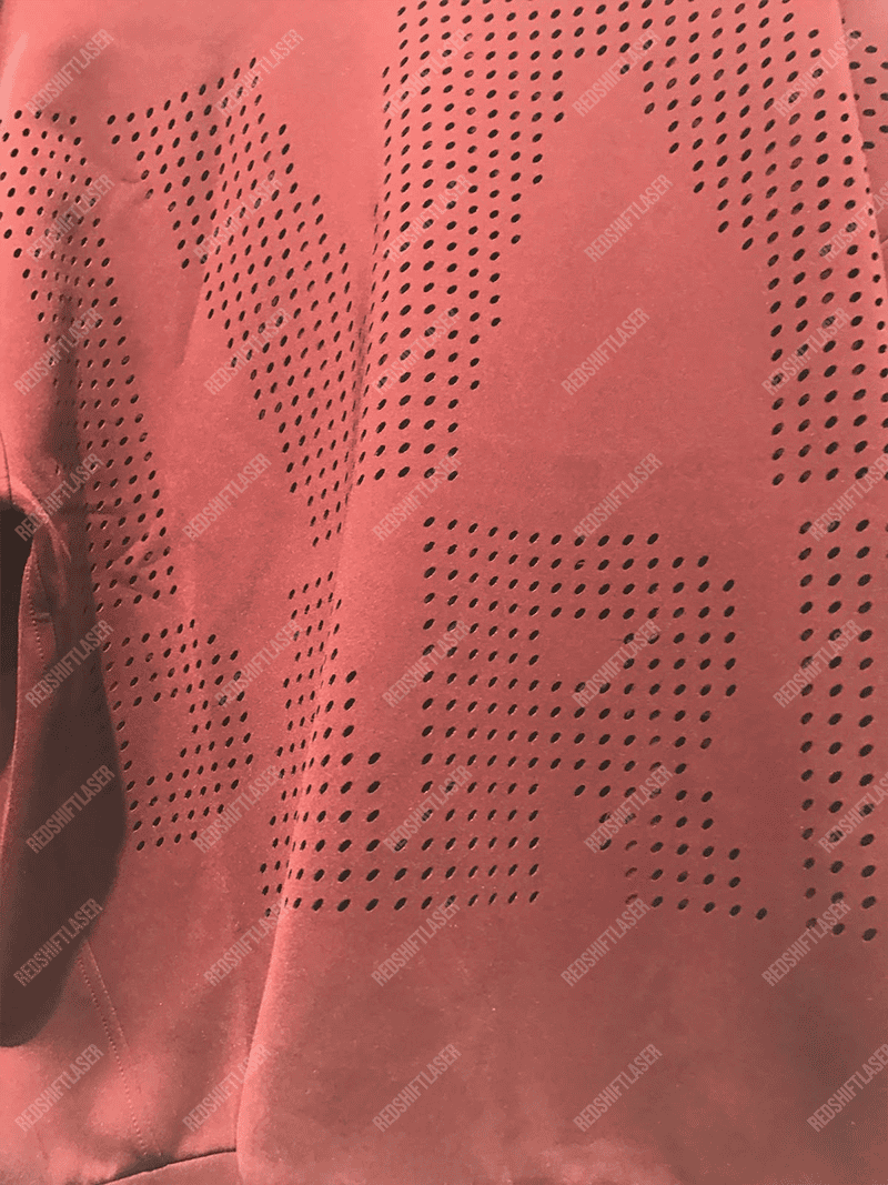 A diagram showing a CO2 laser beam being absorbed by fabric versus a fiber laser beam damaging it