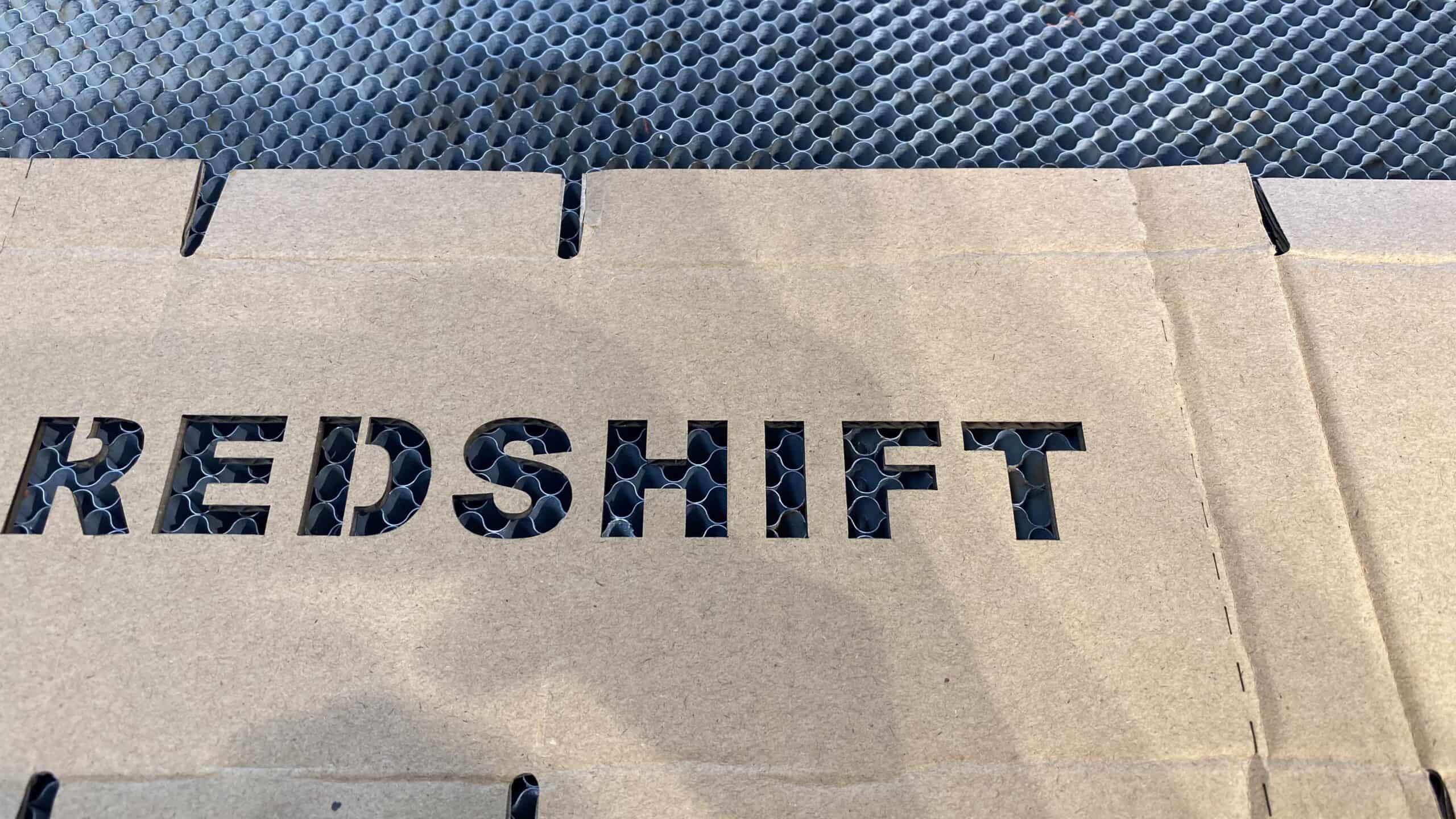 A CO2 laser rapidly cutting intricate designs for a custom box prototype