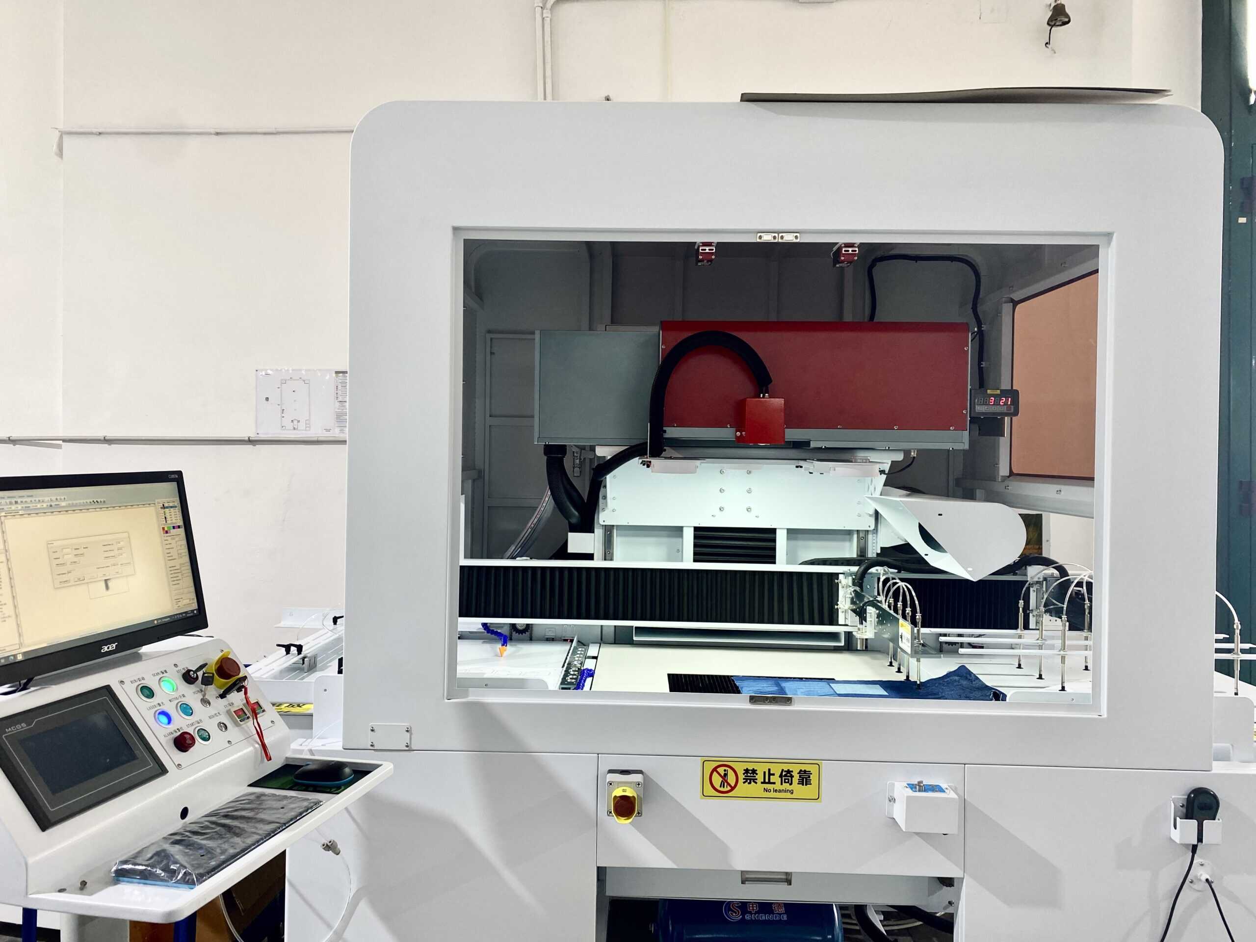 A futuristic depiction of a fully automated factory with robotic arms and lasers