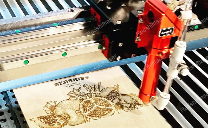 A laser beam cutting through a piece of wood with precision