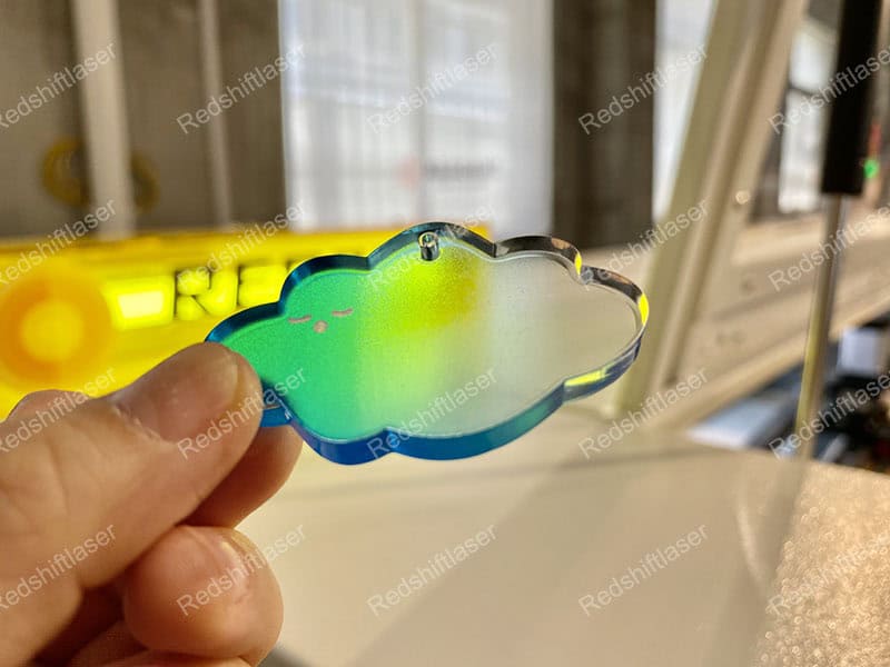 An operator wearing safety glasses while working with a CO2 laser machine