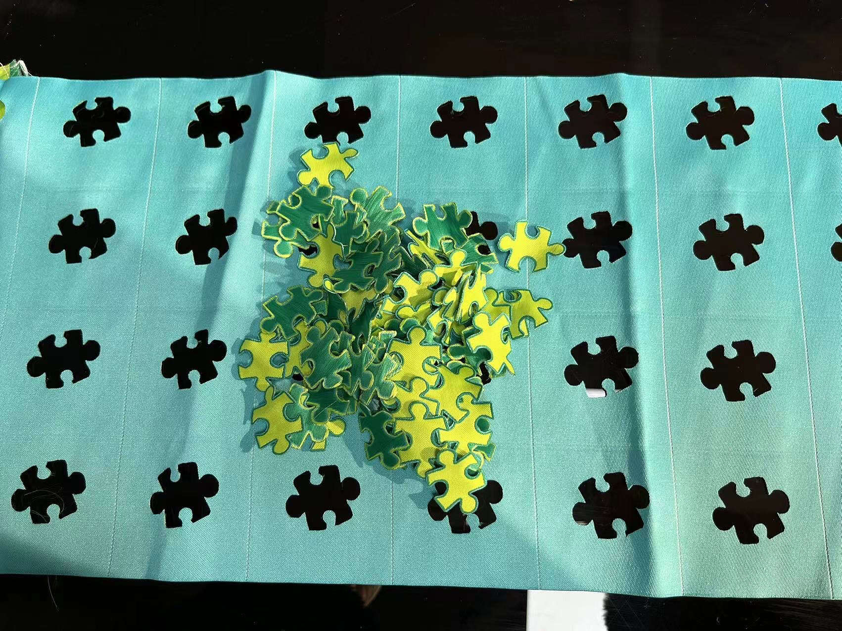 A close-up view of a laser head first raster-engraving a twill patch, then vector-cutting the outline