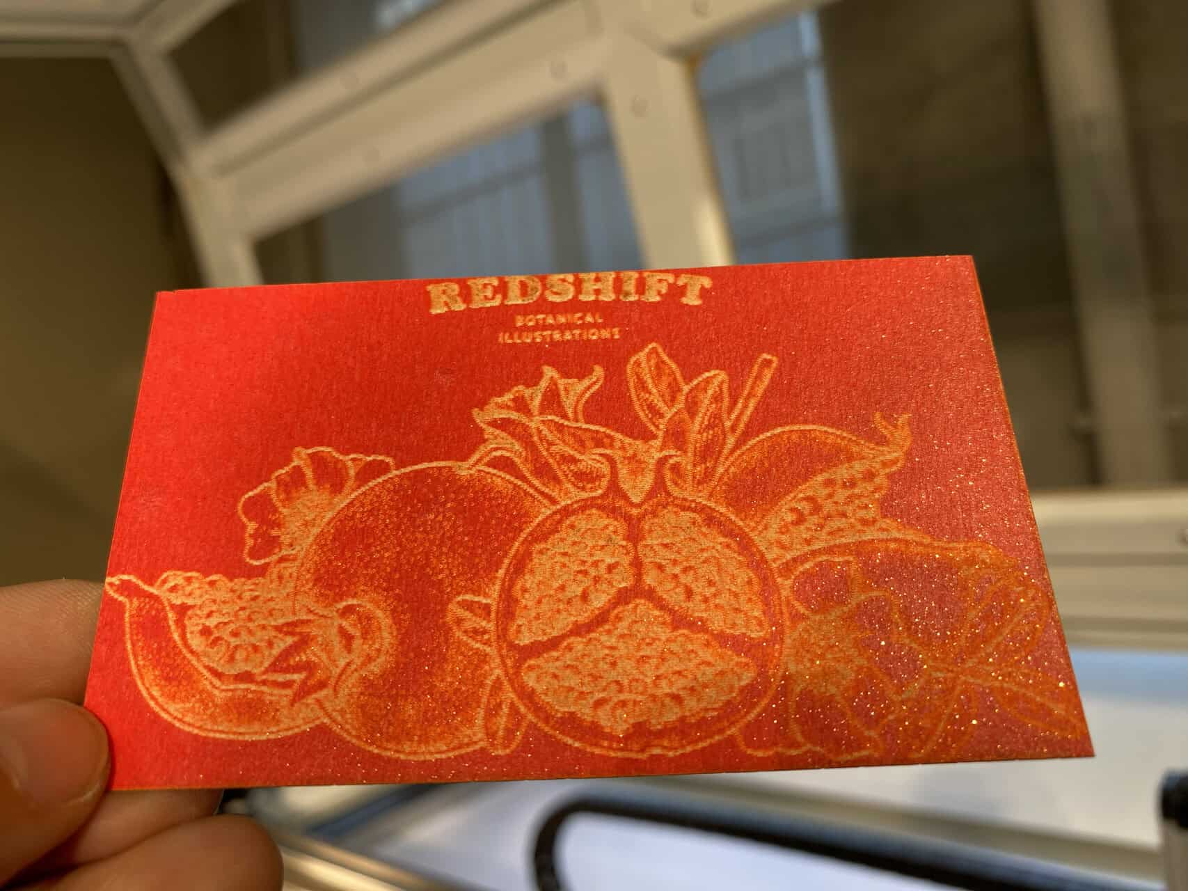 Calibrating Laser Cutter Settings for Paper An operator carefully adjusting laser settings on a computer screen next to the laser cutter