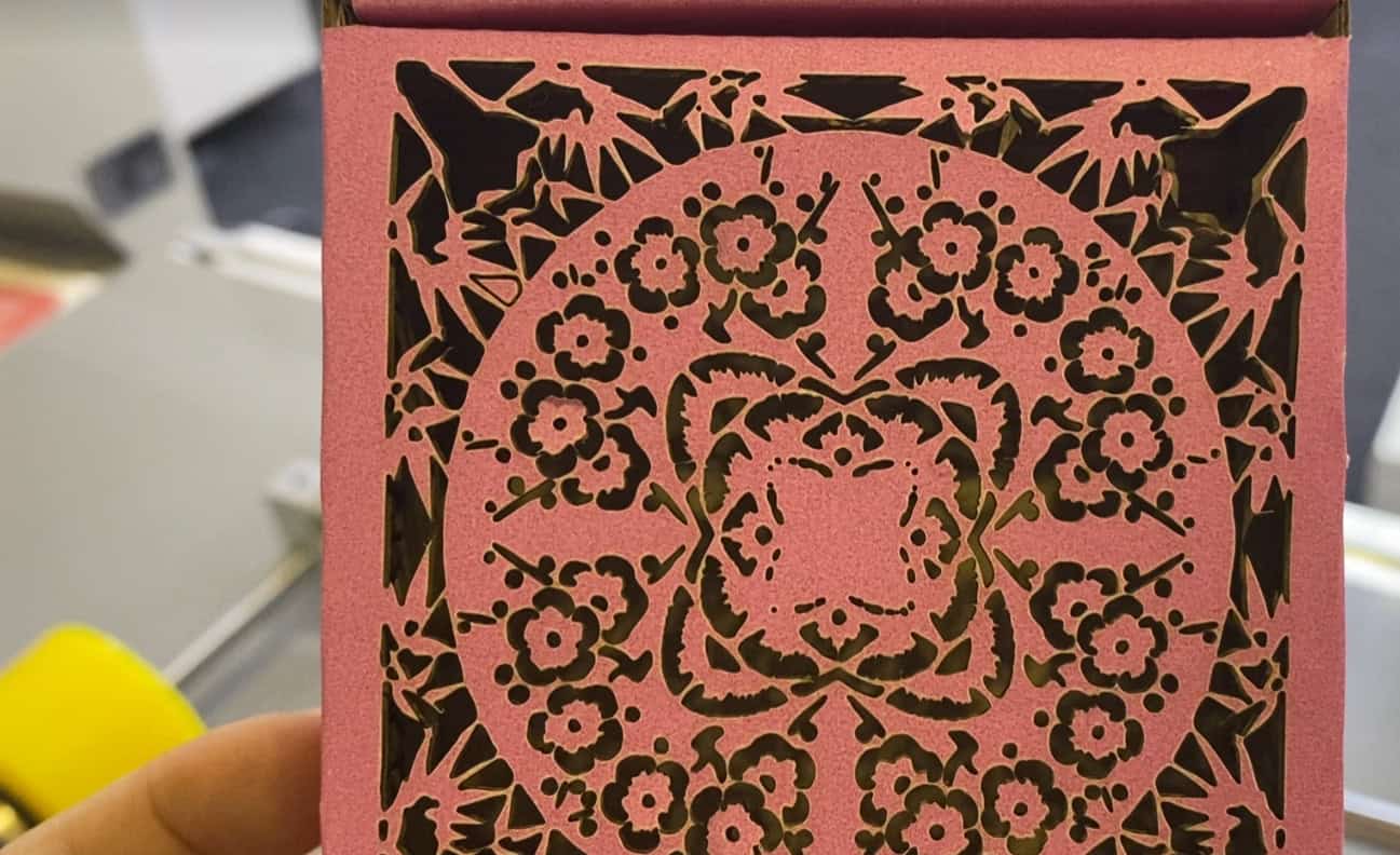 A close-up of a dirty laser lens, showing a hazy film of residue on its surface