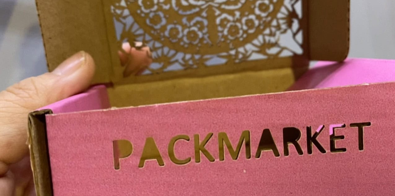 Split image showing a fuzzy, blade-cut edge of cardboard next to a sharp, clean laser-cut edge