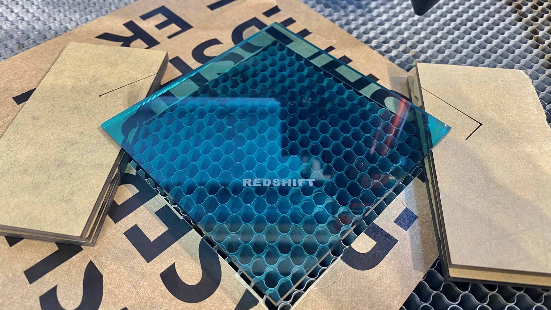 A side-by-side comparison: a plain wooden cutting board next to an intricately laser-engraved one with a family name