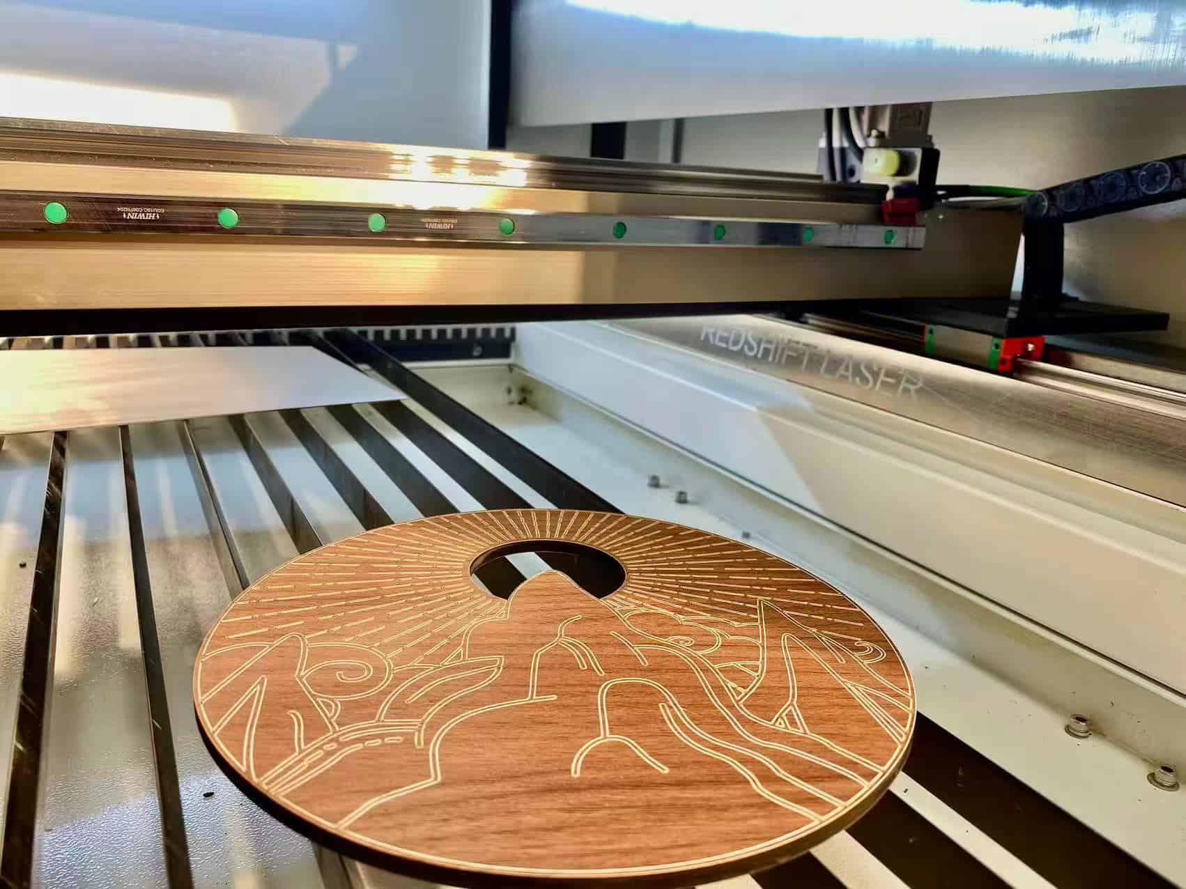 A personalized wooden cutting board with a family name engraved by a CO2 laser