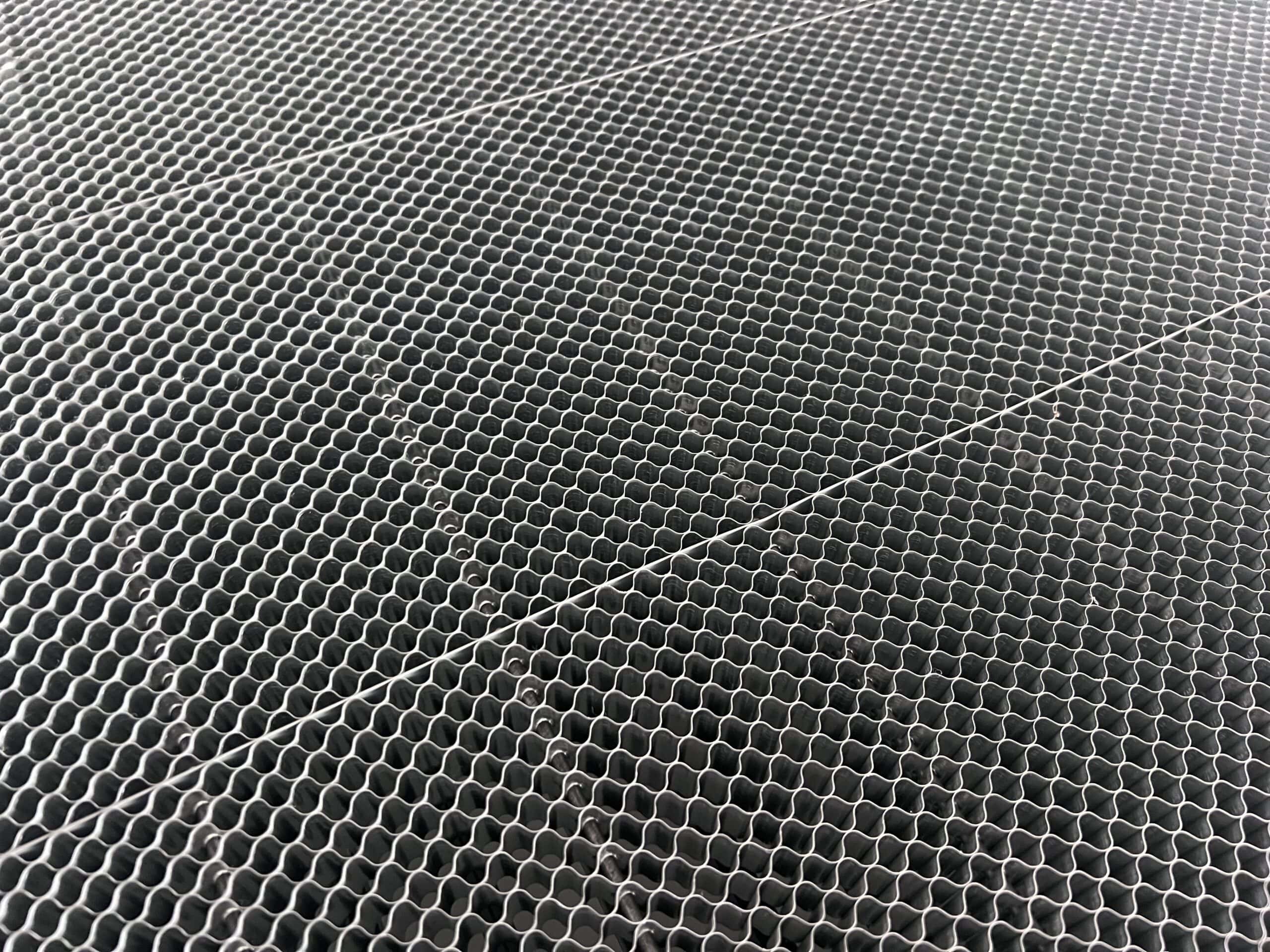Standard aluminum honeycomb laser bed grid reflection marks on white fabric