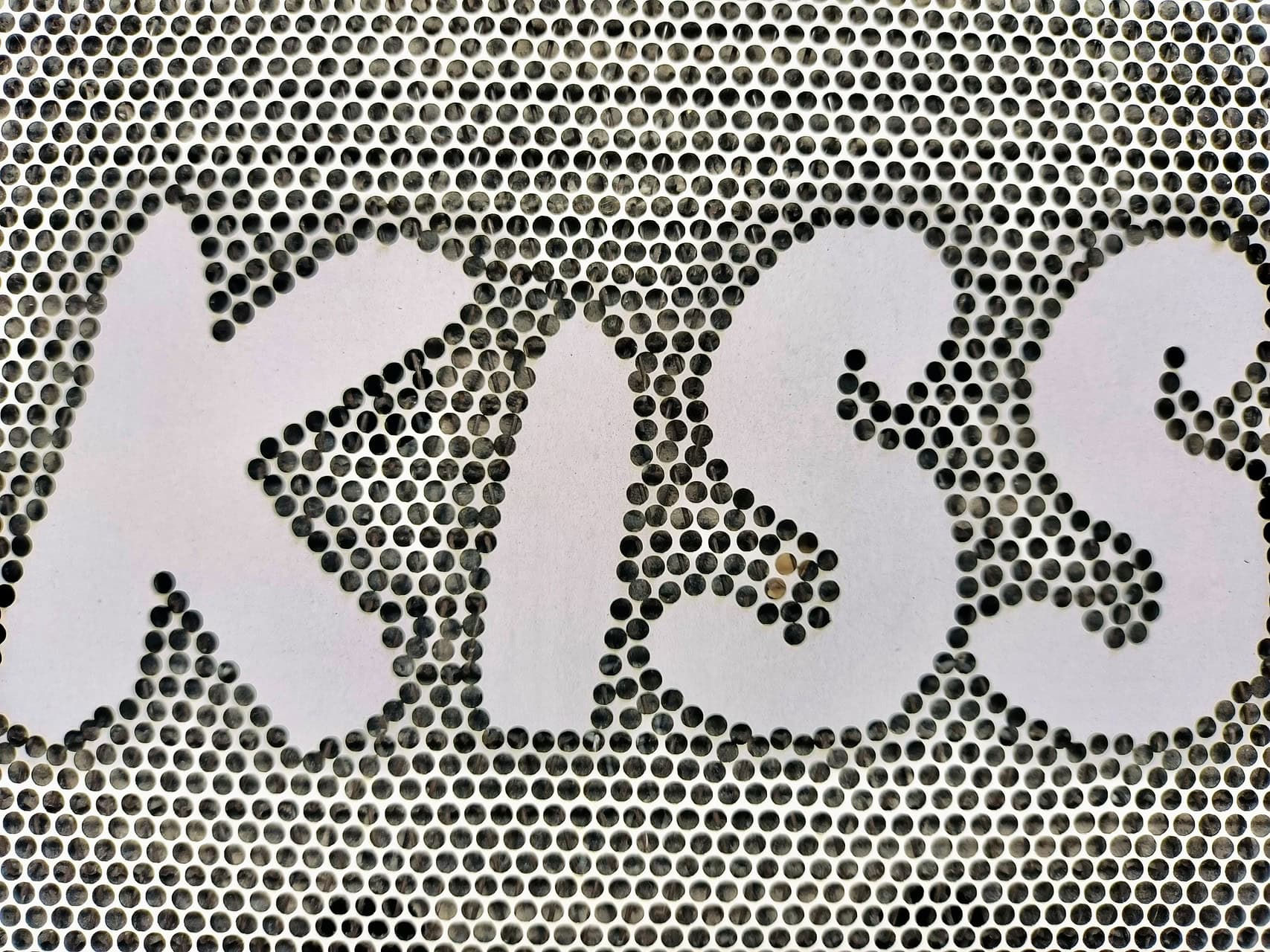 A technician providing hands-on training for a laser machine to a factory team