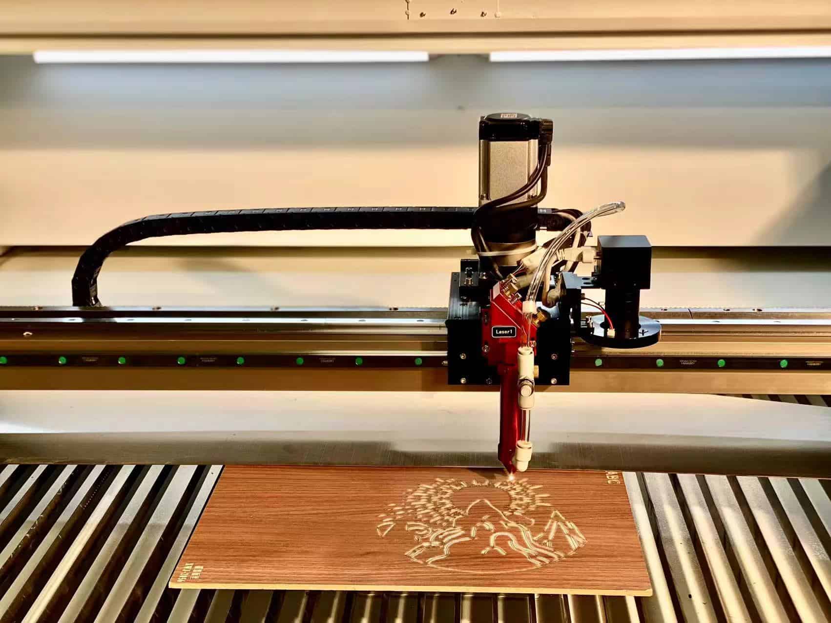 wooden cutting board with a family name engraved by a co2 laser